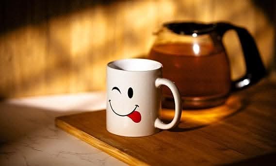 White novelty coffee cups with emoji face designs