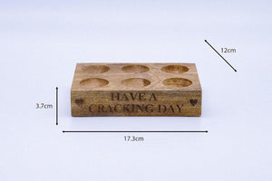 Rustic farmhouse egg holder with printed message.