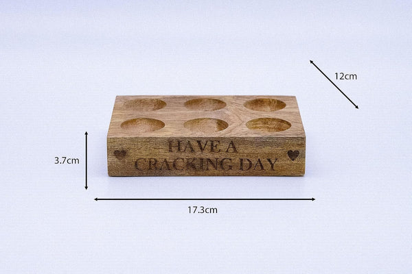 Rustic farmhouse egg holder with printed message.