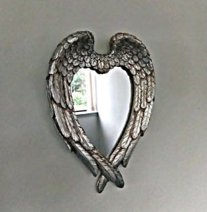 Angel wings heart mirror displayed in hallway