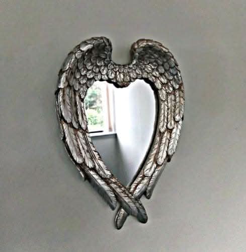 Angel wings heart mirror displayed in hallway