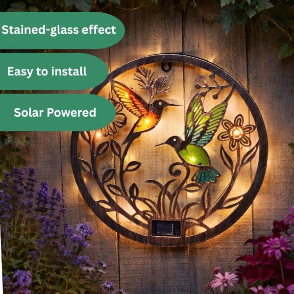 Glass and iron hummingbird wall light for outdoors.