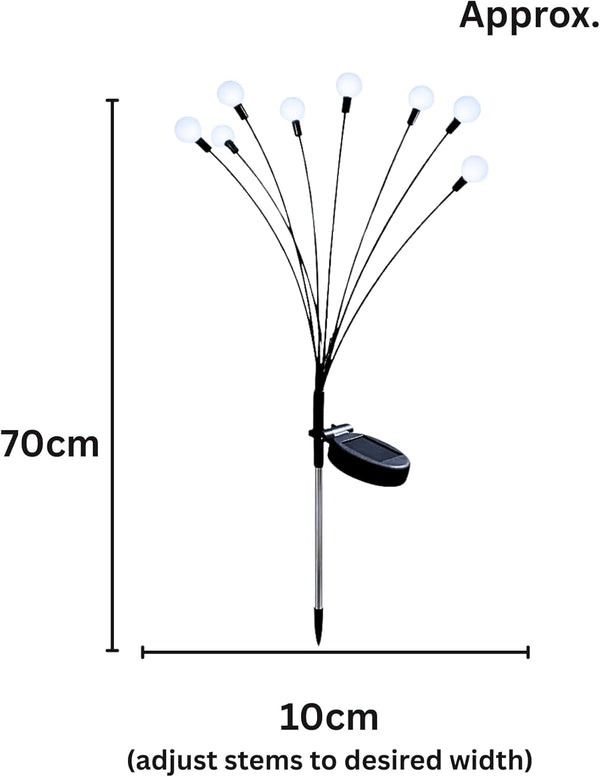Outdoor solar stake light illuminating garden pathway area