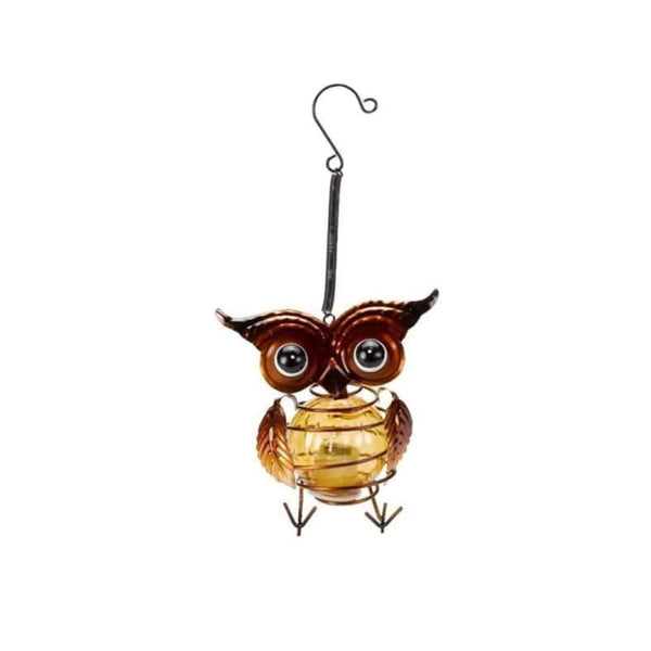 Decorative owl light glowing in an evening garden
