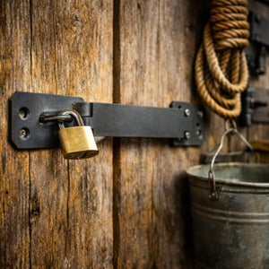Steel security latch fitted to a wooden gate.