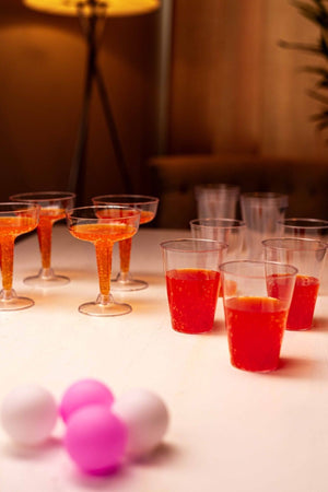 Twelve plastic beer glasses for pong game