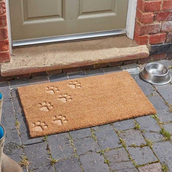 Paw print coir doormat placed at front door entrance