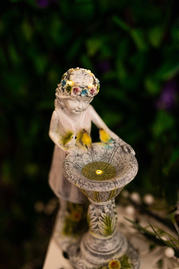 Outdoor fairy statue with bird bath bowl