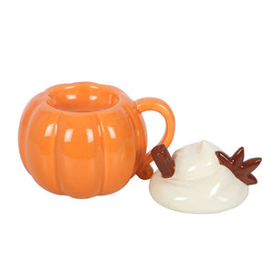 Ceramic pumpkin burner styled with seasonal decorations