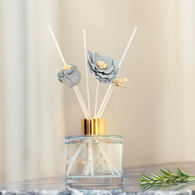 Reed diffuser with floral design on a neutral background
