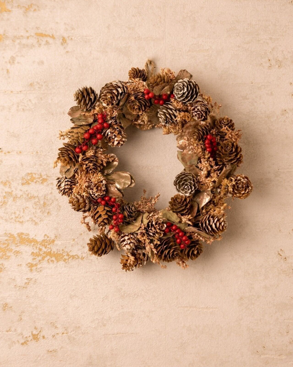 Red berry scented Christmas wreath hanging on a door