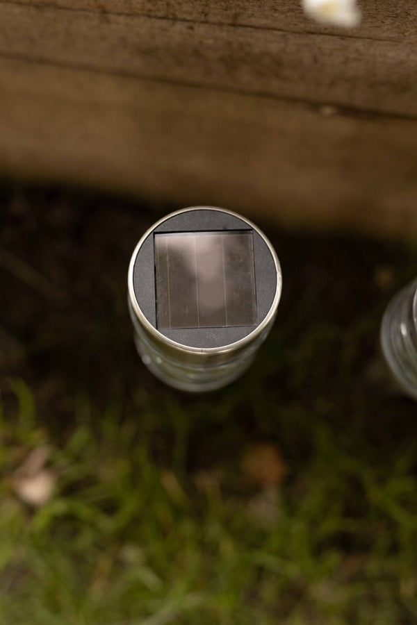 Four solar stake lights displayed outdoors