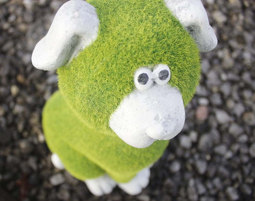 Stone and grass effect dog garden ornament on lawn