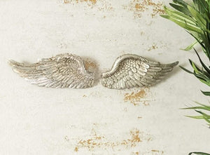 Pair of decorative angel wings shown from the front