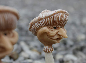 Colourful mushroom ornaments with faux grass bases