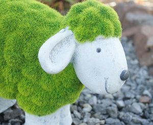 Resin sheep ornament positioned on garden lawn