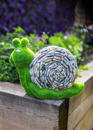 Lightweight garden snail positioned beside pond