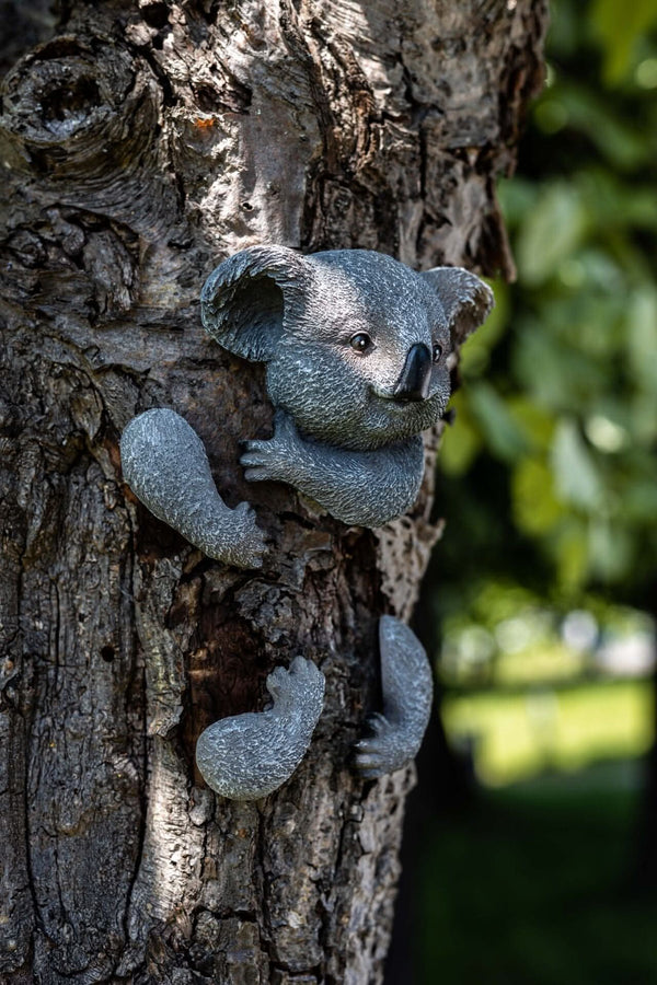Peeking animal decoration attached around a tree trunk