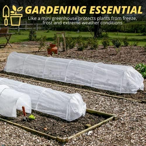 Mini polytunnel covering seedlings in raised bed.