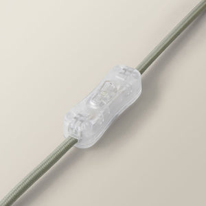 Clear lamp switch on a beige background