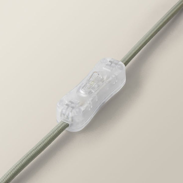 Clear lamp switch on a beige background