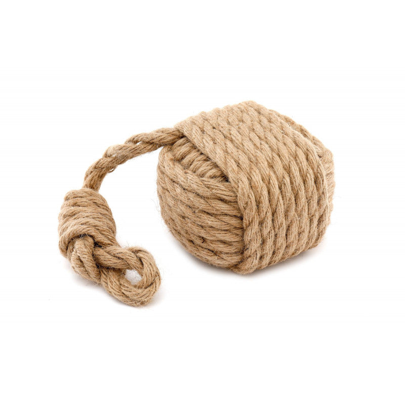 Large ball of rope on a wooden floor with a wooden cabinet in the background.