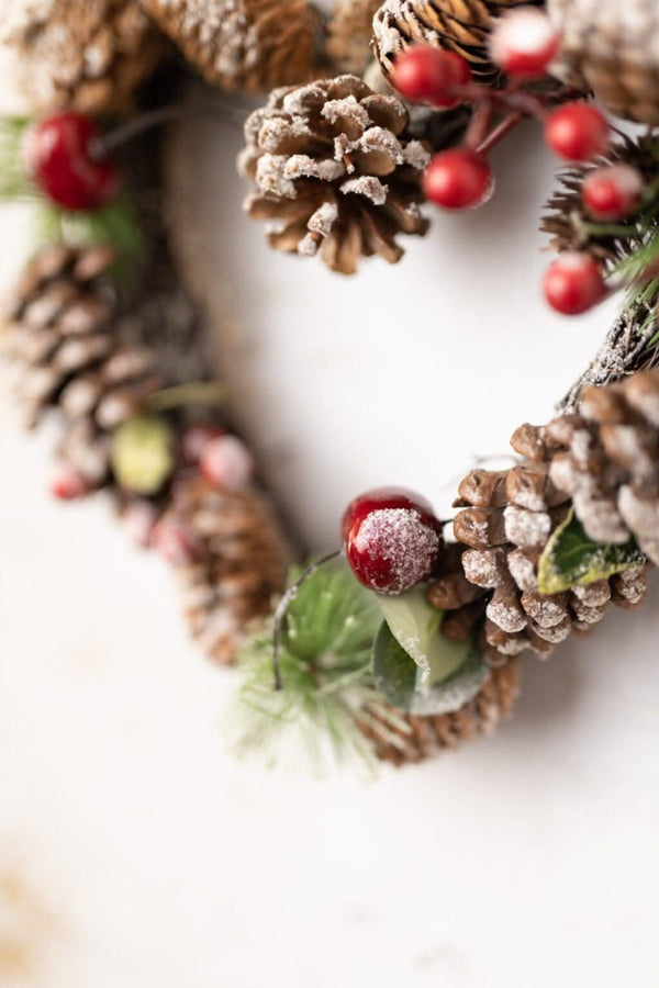 Christmas heart decoration featuring berries and faux leaves