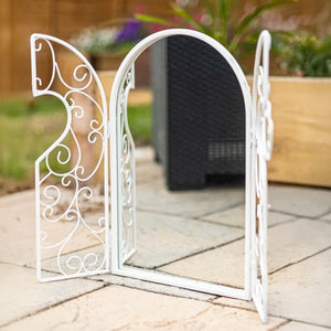 Arched window style mirror used as wall decor
