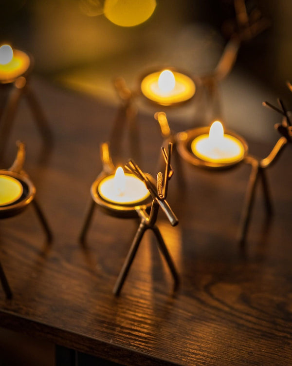 Reindeer tea light holders arranged on a Christmas table