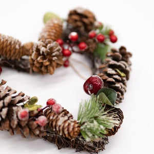 Botanical winter wreath suspended by a jute cord