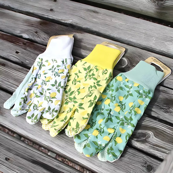 Three pairs of gardening gloves with lemon pattern on a wooden surface