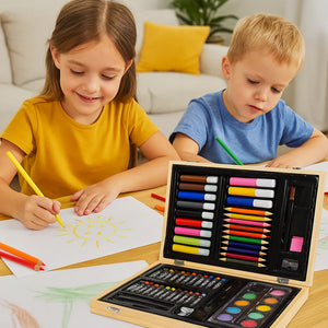 Two children drawing with a set of art supplies on a table.