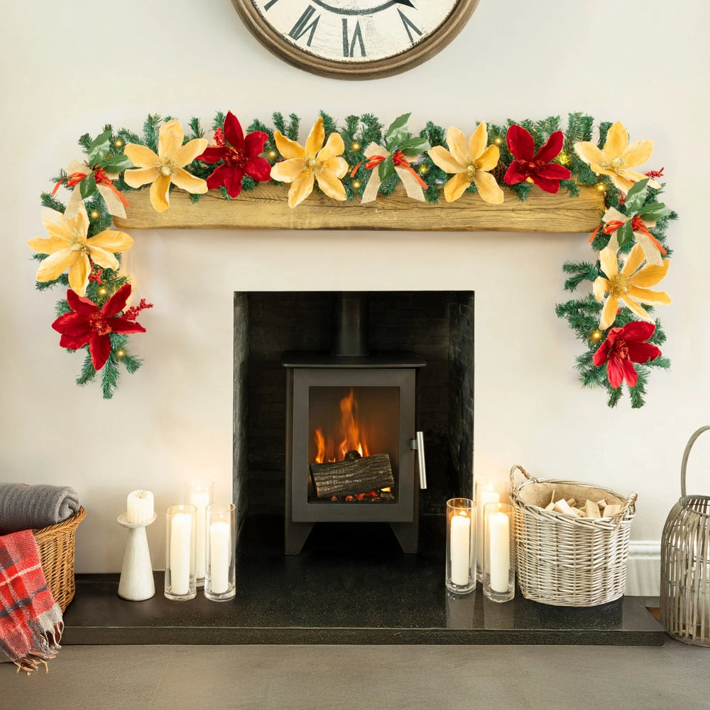 Decorated fireplace with Christmas garland, candles, and a clock above.