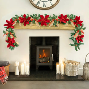 Decorated fireplace with Christmas garland, candles, and wood basket.