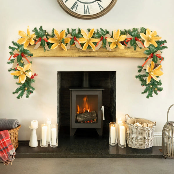 Decorated fireplace with garland, candles, and a clock above.