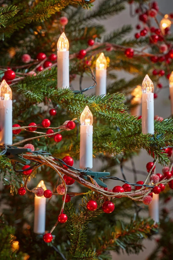 Decorative Christmas tree with candles and red berries