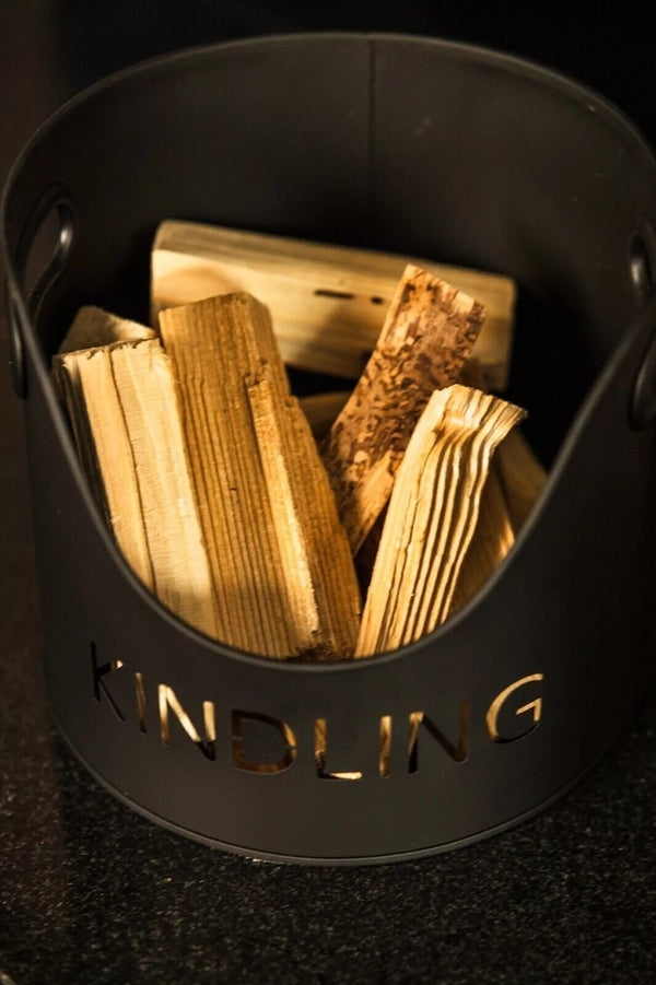 Black container labeled 'Kindling' with wooden kindling inside on a dark background