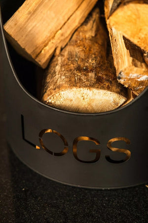 Wooden logs in a metal container with 'LOGS' engraving on a dark background