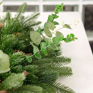 Close-up of artificial greenery on a white surface
