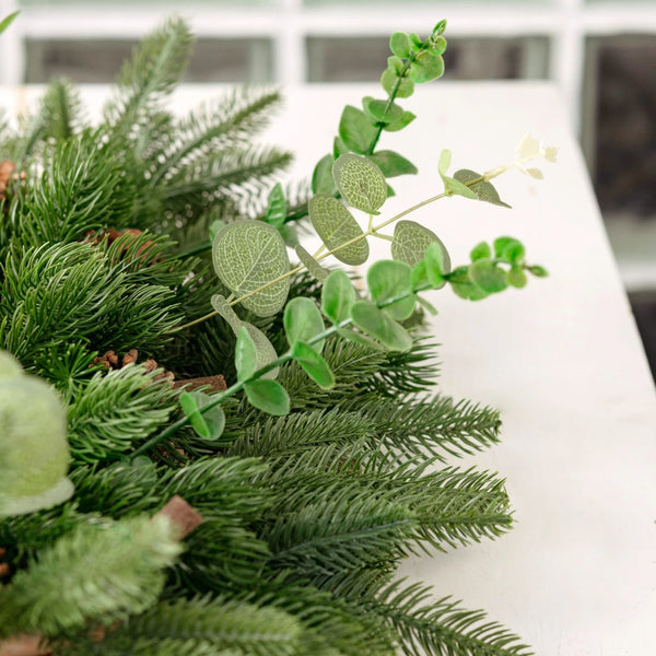 Close-up of artificial greenery on a white surface