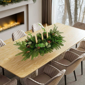 Dining table set with a festive centerpiece in a cozy room with a fireplace.