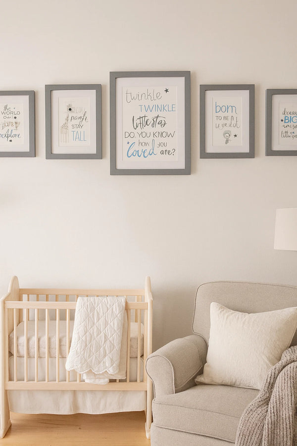 Nursery room with wooden crib and armchair, featuring framed text art on the wall.