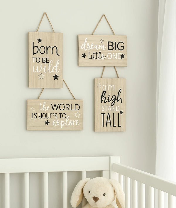 Nursery room with motivational wooden signs and a stuffed animal.