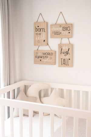 Nursery room with wooden signs above a crib