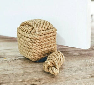 Coiled rope on a wooden surface with a white background