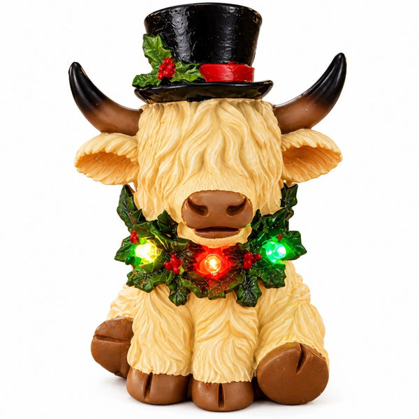 White Christmas Highland cow ornament with multicoloured LED lights on white background.