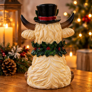 Rear view of resin Christmas Highland cow showing detailed cream fur.