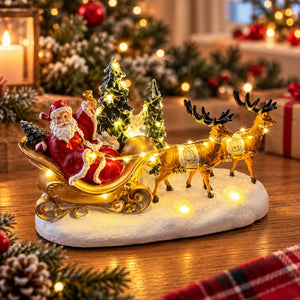 Santa in gold sleigh with illuminated reindeer on snowy Christmas base