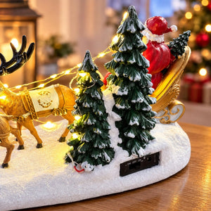 Rear view of Santa sleigh ornament showing snowy trees and controls