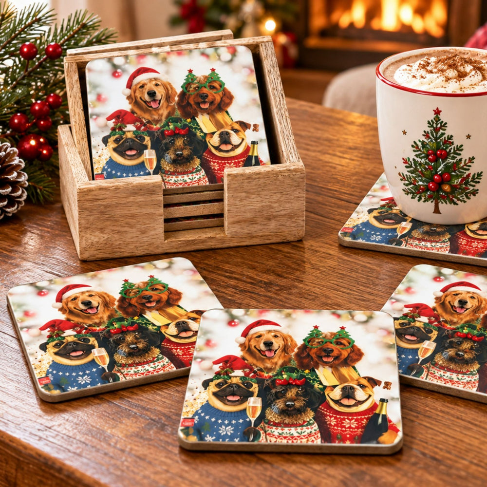 A set of square coasters with a printed holiday design of four dogs in festive sweaters and Santa hats, displayed on a wooden table alongside a wooden holder and a Christmas-themed mug.